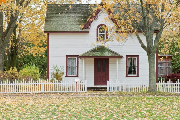 white house under maple trees