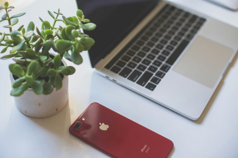 red iphone 7 on macbook pro